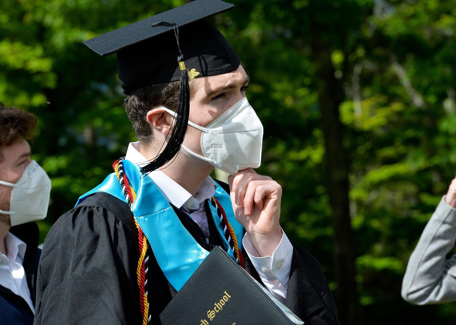 A student putting his mask back on during the Kenneth High School graduation in North Conway, New Hampshire